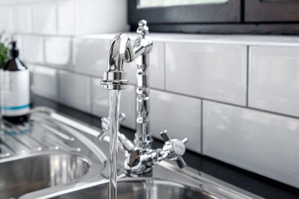 The new and  modern steel faucet in the kitchen
